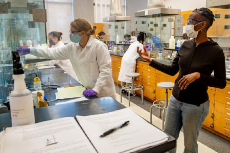 Tulane teacher in science lab helping student